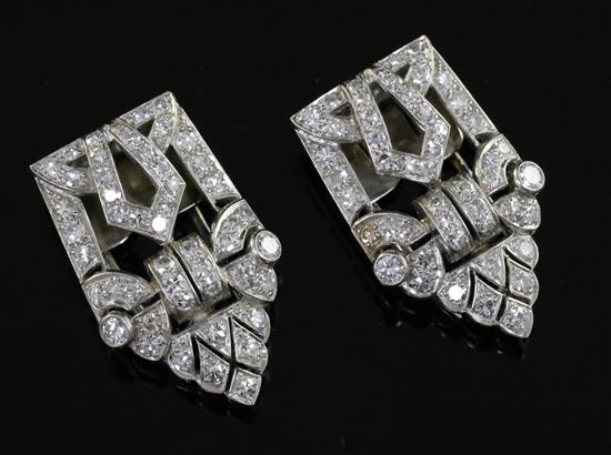 A pair of Art Deco diamond dress clips, of typical openwork geometric form, millegrain-set in platinum, 27mm.